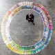 A person surrounded by color chips.