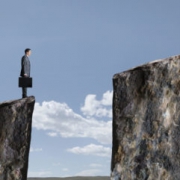 Businessman Standing At Edge Of Cliff