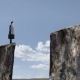 Businessman Standing At Edge Of Cliff